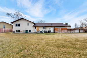 Rear view of property featuring a fenced backyard, a shed, and a patio area