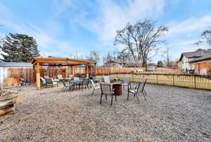 Fenced backyard with a patio and outdoor seating