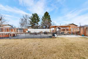 Fenced backyard with a patio area