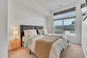 Carpeted bedroom featuring baseboards