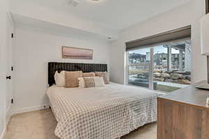 Bedroom with light carpet and baseboards