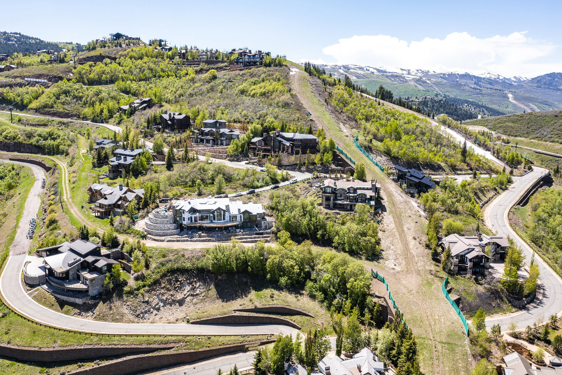 Hillside residences situated on terraced lots with curving paved roads