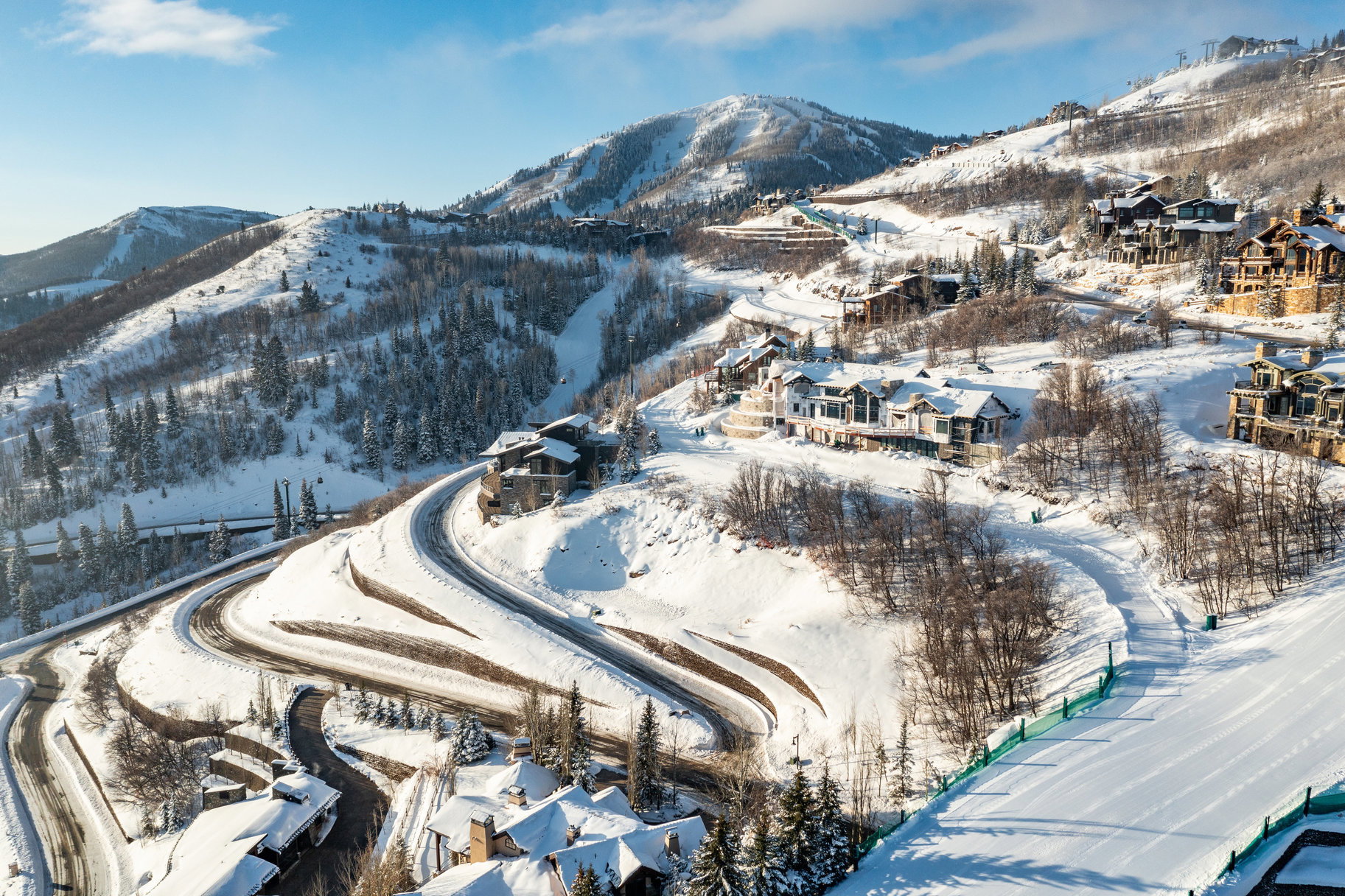 Mountainous landscape featuring snow-covered peaks and evergreen trees
