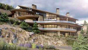 Back of property with a chimney and stone siding