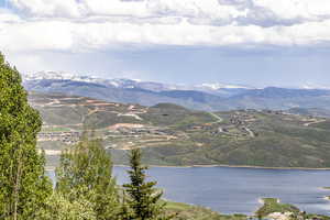 View of mountain backdrop featuring a nearby body of water