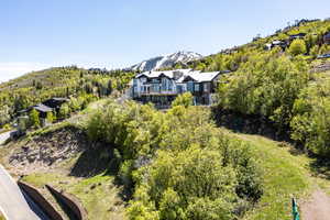 View of front of property with a mountain view and a balcony