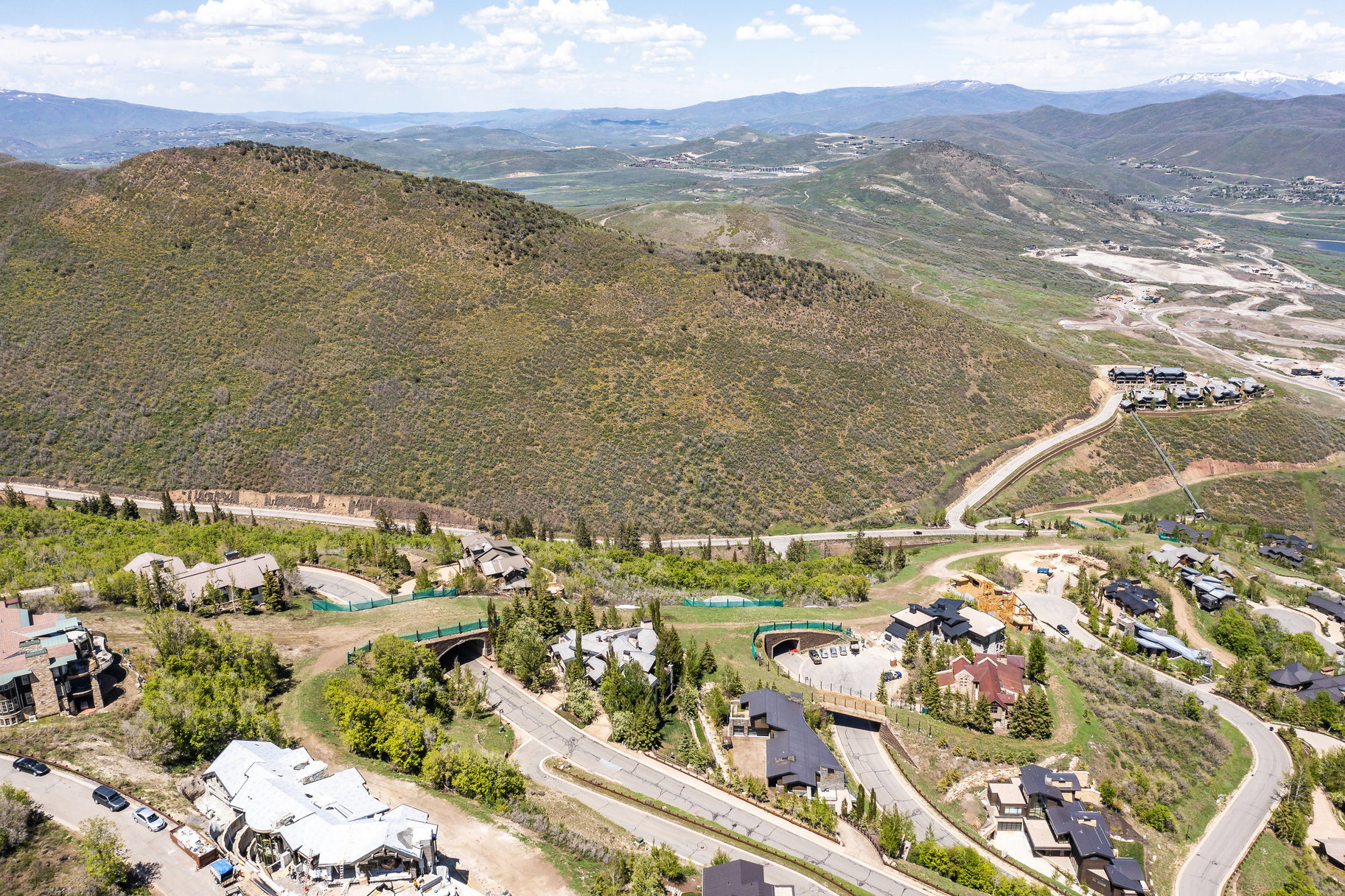 Sloped terrain with established residences featuring varied architectural styles