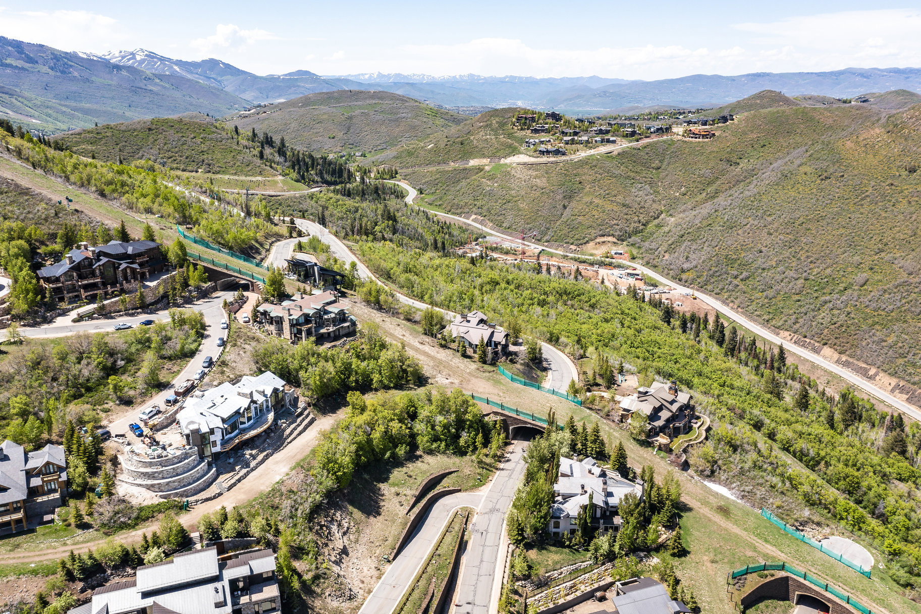 Mountainous landscape featuring multiple luxury residences and winding roadways
