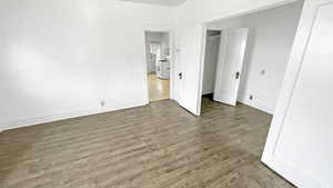 Unfurnished bedroom featuring a closet and wood finished floors