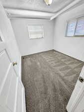 Spare room with carpet floors and a textured ceiling