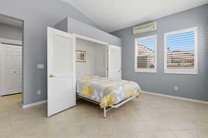 Bedroom featuring lofted ceiling and light tile patterned flooring