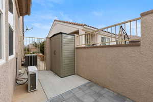 Patio / terrace featuring a shed
