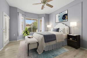 Bedroom featuring a ceiling fan, light wood-type flooring, and access to outside