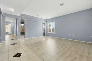 Empty room featuring light wood finished floors and baseboards