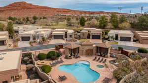 Community pool with a patio area, a mountain view, and a residential view