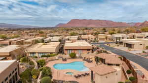 Community pool featuring a residential view, a community hot tub, a mountain view, and a patio area