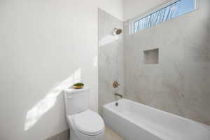 Bathroom with shower / bathtub combination and toilet