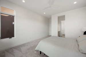 Bedroom featuring light carpet, a ceiling fan, recessed lighting, and connected bathroom