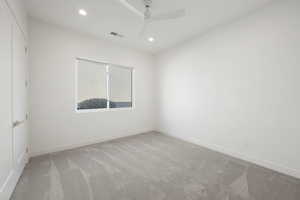 Spare room with light carpet, recessed lighting, and ceiling fan
