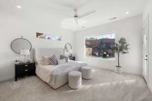 Bedroom with light carpet, a ceiling fan, and recessed lighting