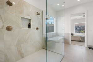 Full bath with a walk in shower, ensuite bathroom, a freestanding tub, and tile patterned flooring