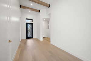 Entryway with beam ceiling, light wood-type flooring, and recessed lighting