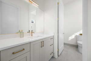 Bathroom featuring vanity and toilet