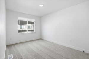 Carpeted empty room with baseboards