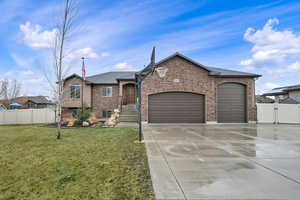 View of front facade with a garage, brick siding, driveway, a gate, and a shingled roof