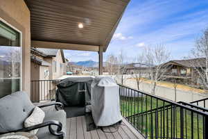 Balcony featuring a mountain view, grilling area, and a residential view