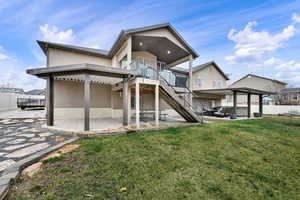 Rear view of house featuring a fenced backyard, a patio, and a wooden deck