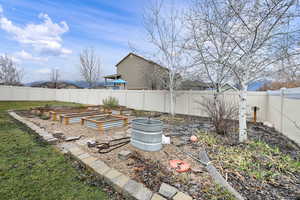 Fenced backyard with a vegetable garden