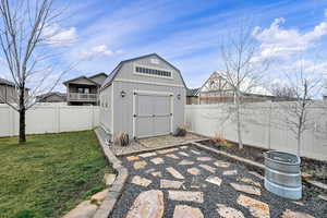 View of shed with a fenced backyard