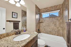 Bathroom with vanity and shower / washtub combination