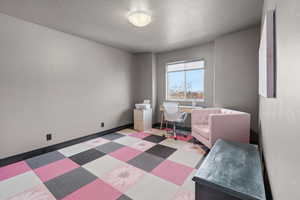Bedroom with baseboards and a textured ceiling