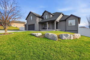 View of front of home with an attached garage, stucco siding, driveway, and covered porch
