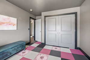 Bedroom featuring tile patterned floors and a closet