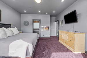 Bedroom featuring carpet floors, ensuite bathroom, and recessed lighting