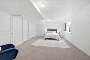 Carpeted bedroom featuring baseboards and a textured ceiling