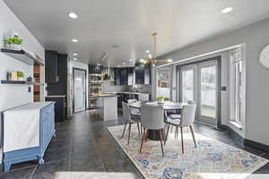 Dining area with hanging lights and baseboards