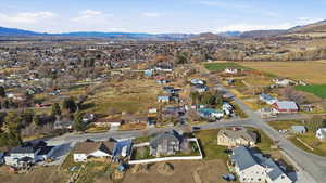 Aerial overview of property's location with a mountain backdrop and nearby suburban area
