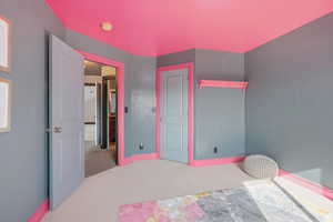 Bedroom with carpet flooring and baseboards