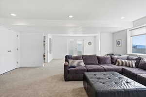 Living area featuring french doors, carpet floors, and recessed lighting