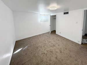 bedroom with carpet and a closet