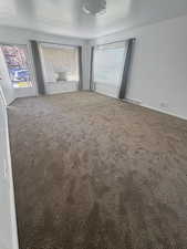 bedroom featuring dark colored carpet and baseboards