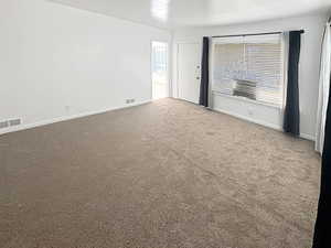 Carpeted room with healthy amount of natural light