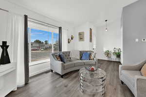 Living room with vaulted ceiling and wood finished floors