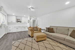 Living area featuring recessed lighting, light wood-style flooring, and a textured ceiling