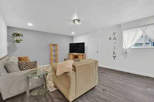 Living room featuring wood finished floors and recessed lighting