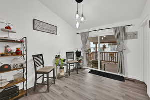 Sitting room with lofted ceiling and light wood finished floors